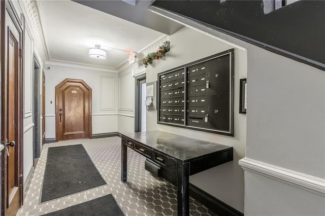 interior space featuring a mail area and ornamental molding