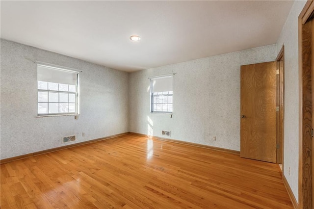 spare room featuring light wood-type flooring