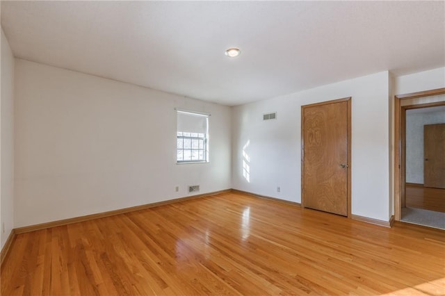 spare room with light hardwood / wood-style floors