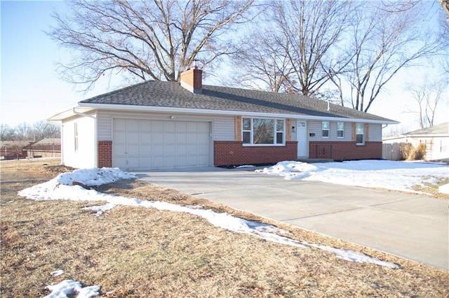 ranch-style home featuring brick siding, concrete driveway, a chimney, and an attached garage