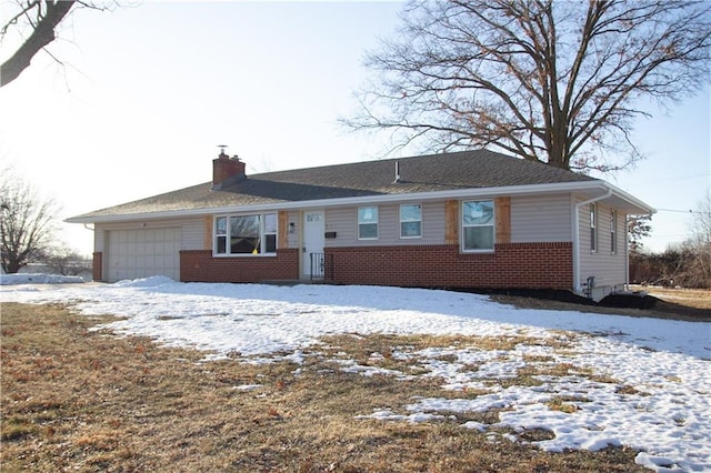 ranch-style house with a garage, brick siding, and a chimney