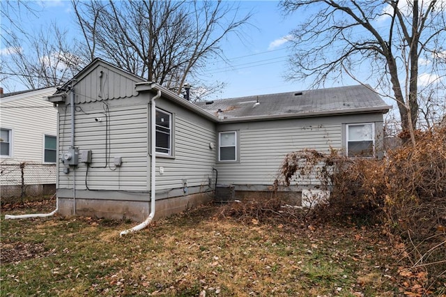 rear view of property with a lawn