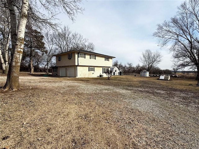 view of home's exterior featuring a garage and a shed