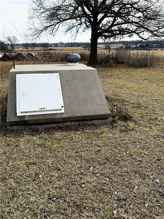 view of storm shelter with a rural view