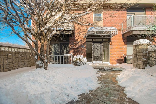 view of snow covered property entrance