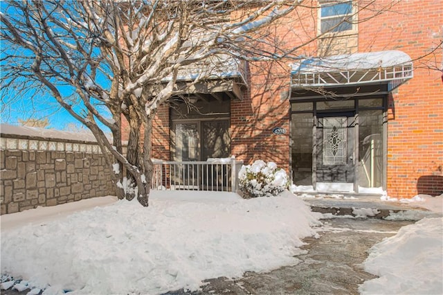 view of snow covered property entrance