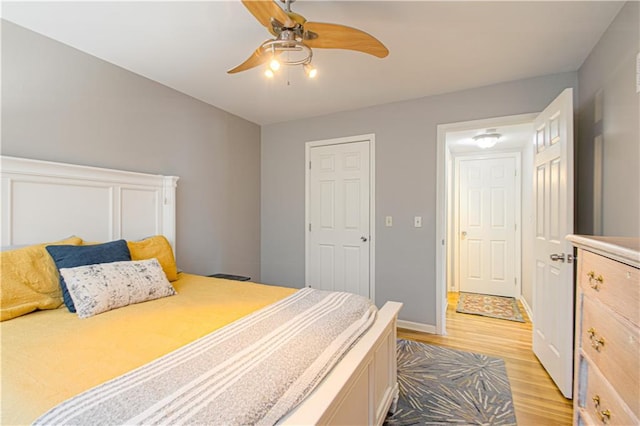 bedroom with ceiling fan and light hardwood / wood-style floors