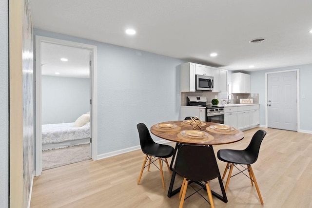 dining room featuring light hardwood / wood-style floors and sink