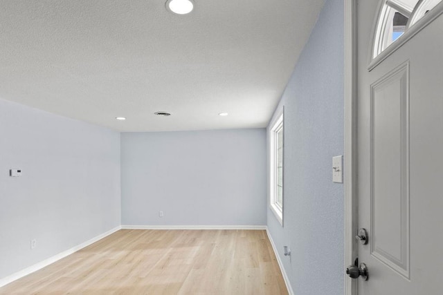 spare room featuring light hardwood / wood-style floors