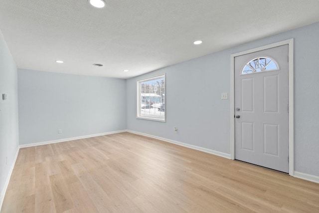 foyer entrance with light wood-type flooring