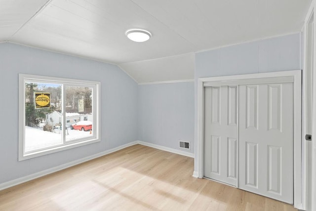 additional living space with lofted ceiling and light hardwood / wood-style flooring