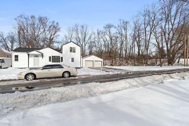 view of front of property featuring a garage and an outdoor structure