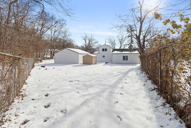 snowy yard with a storage unit