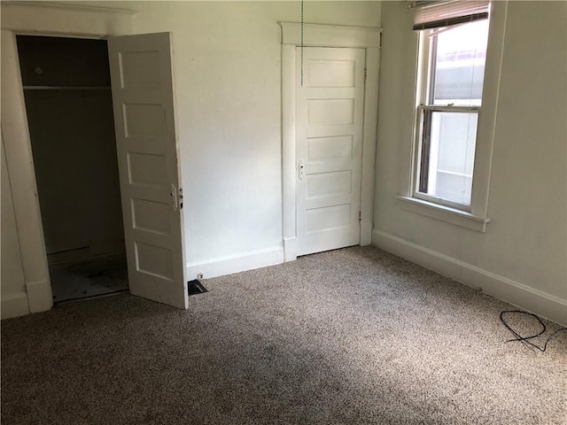 unfurnished bedroom with a closet and carpet floors