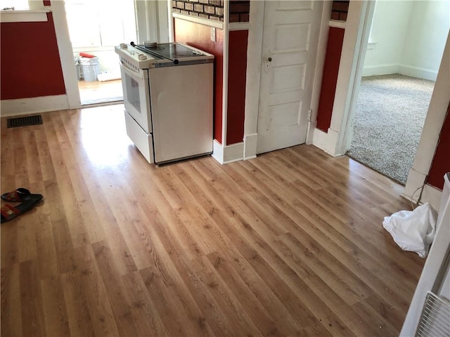 kitchen with white electric stove and light wood-type flooring