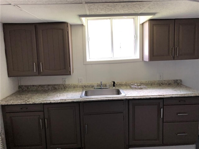 kitchen featuring sink and dark brown cabinetry