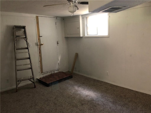 basement with carpet flooring and ceiling fan