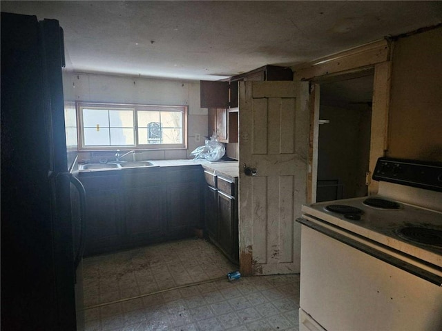 kitchen featuring sink and white electric range oven