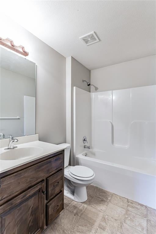 full bathroom featuring toilet, vanity, shower / bathtub combination, and a textured ceiling