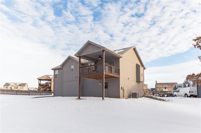 snow covered house featuring ceiling fan, central air condition unit, a gazebo, and a balcony