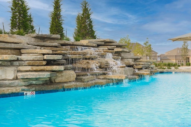 view of pool with pool water feature