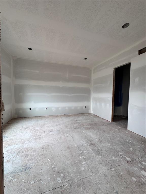 unfurnished room featuring visible vents and a textured ceiling