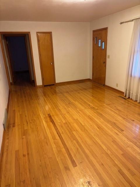 empty room with light hardwood / wood-style floors