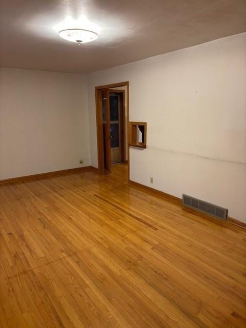 empty room with light hardwood / wood-style flooring