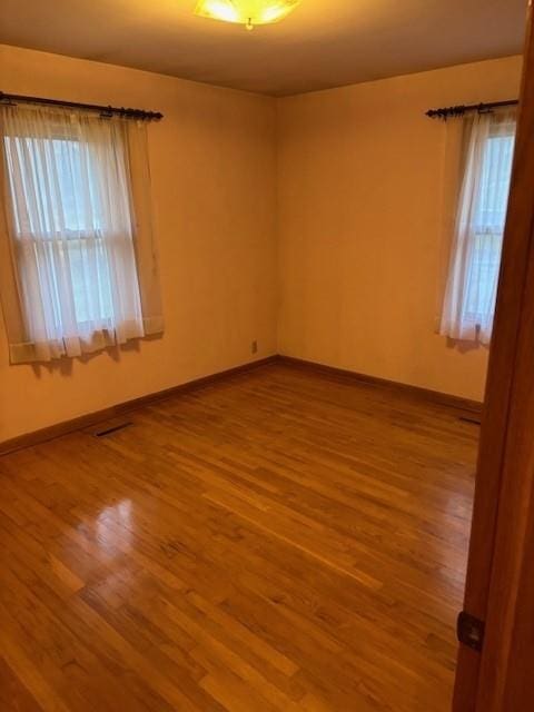 empty room featuring wood-type flooring