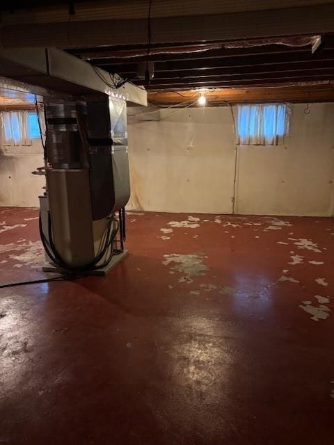 basement featuring heating unit and a wealth of natural light