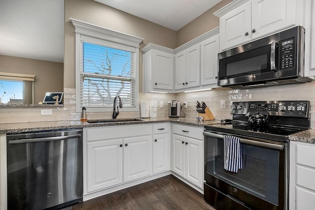 kitchen with sink, dishwasher, dark stone countertops, black range with electric stovetop, and white cabinets