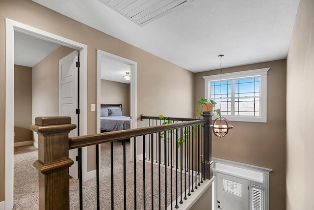 staircase featuring carpet flooring and an inviting chandelier