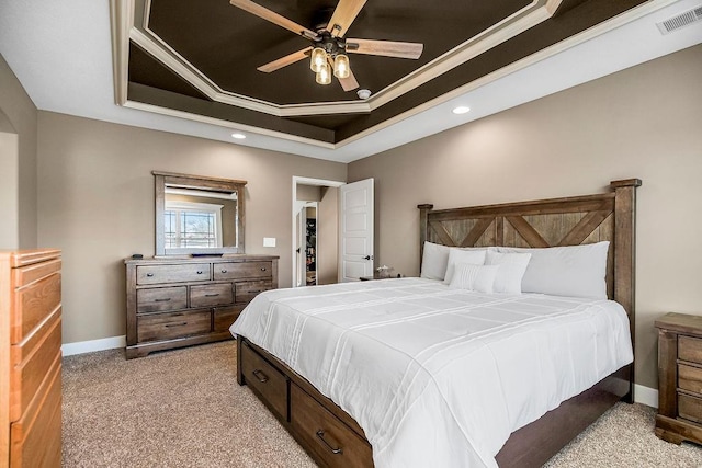 carpeted bedroom featuring ornamental molding, a raised ceiling, and ceiling fan