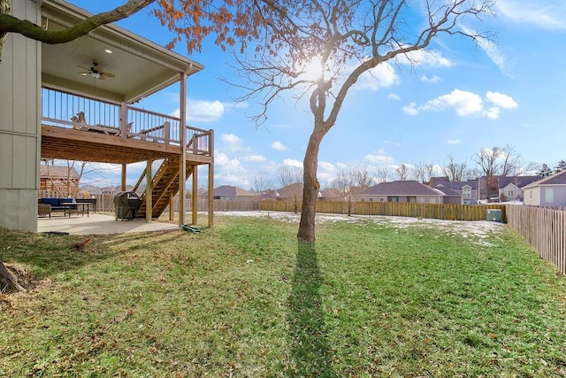 view of yard with a wooden deck, a patio area, and ceiling fan