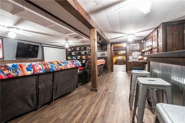 living room with bar area and hardwood / wood-style floors