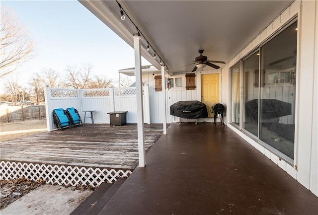 wooden terrace featuring grilling area and ceiling fan