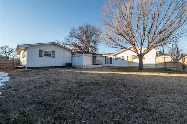 rear view of house featuring a yard