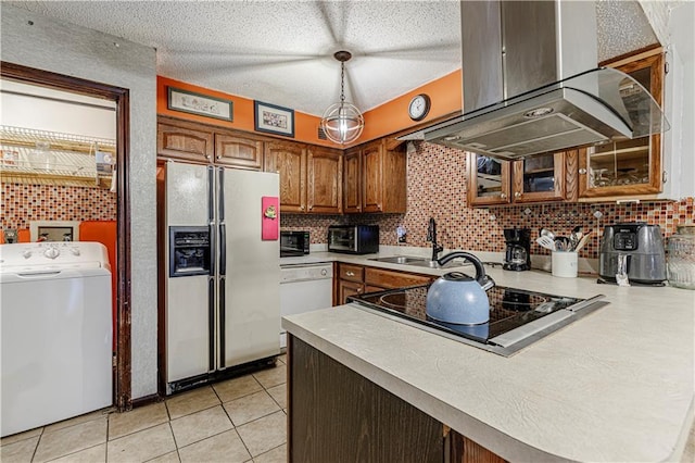 9215 E 85th St, Raytown, MO 64138 - kitchen featuring island range hood, tasteful backsplash, white appliances, and washer / dryer