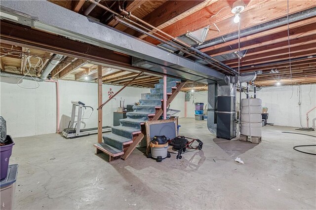 9215 E 85th St, Raytown, MO 64138 - unfinished below grade area featuring heating unit, water heater, and stairs