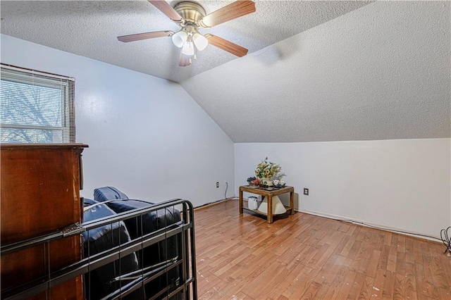 9215 E 85th St, Raytown, MO 64138 - additional living space featuring a textured ceiling, ceiling fan, light wood-type flooring, and lofted ceiling