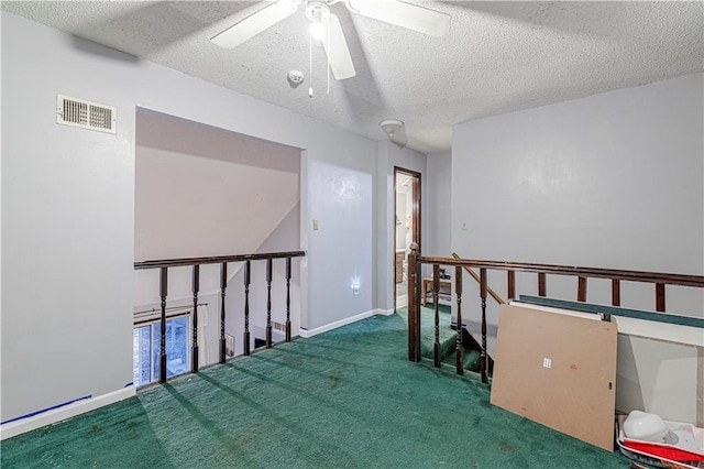 9215 E 85th St, Raytown, MO 64138 - interior space featuring a textured ceiling, a ceiling fan, visible vents, carpet floors, and baseboards