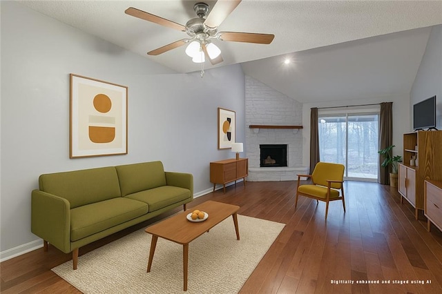 9215 E 85th St, Raytown, MO 64138 - living room with a large fireplace, hardwood / wood-style flooring, and lofted ceiling