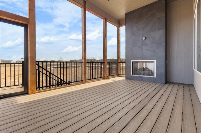 wooden terrace featuring a tile fireplace