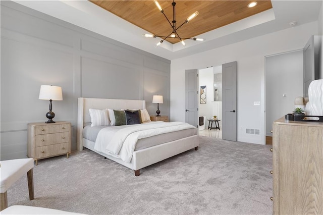 carpeted bedroom featuring an inviting chandelier, wooden ceiling, and a raised ceiling