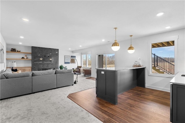 kitchen featuring hanging light fixtures, dark hardwood / wood-style flooring, and kitchen peninsula