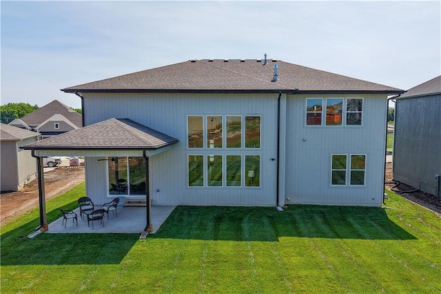 17186 S Heatherwood St, Olathe, KS 66062 - back of property with a patio, a lawn, and roof with shingles