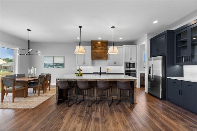 17186 S Heatherwood St, Olathe, KS 66062 - kitchen featuring appliances with stainless steel finishes, dark wood-style flooring, tasteful backsplash, light countertops, and recessed lighting