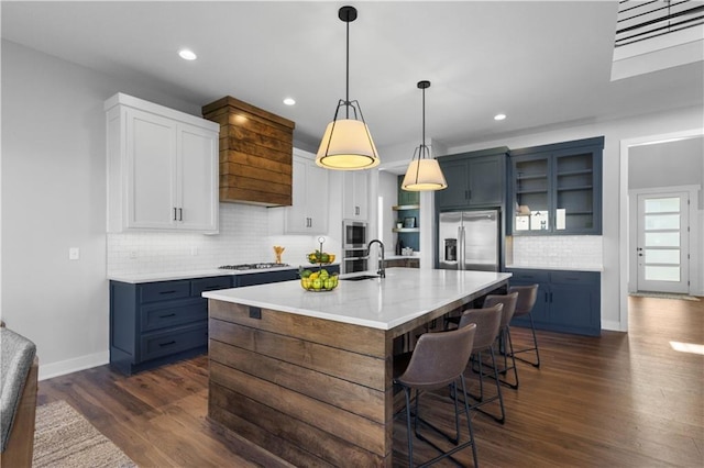 17186 S Heatherwood St, Olathe, KS 66062 - kitchen featuring appliances with stainless steel finishes, open shelves, a breakfast bar, decorative backsplash, and dark wood-style floors