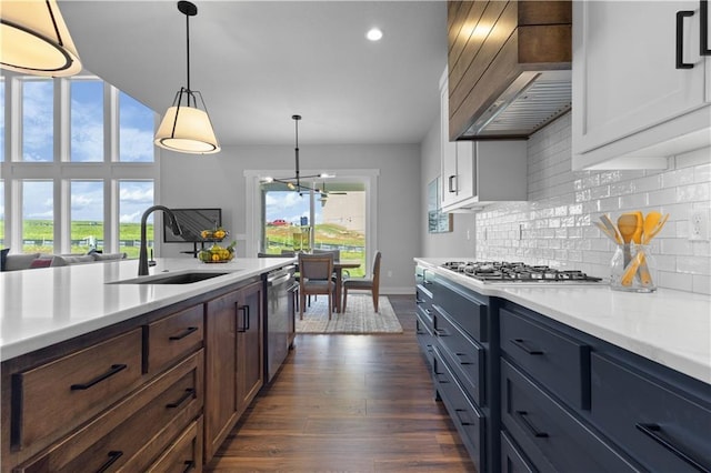 17186 S Heatherwood St, Olathe, KS 66062 - kitchen with a sink, premium range hood, stainless steel appliances, light countertops, and decorative backsplash