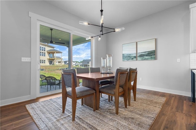 17186 S Heatherwood St, Olathe, KS 66062 - dining space with a chandelier, dark wood finished floors, and baseboards